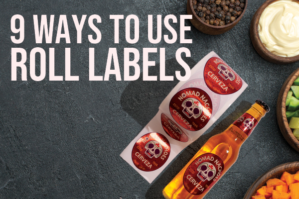 9 Ways To Use Roll Labels text on a grey slate table with bowls of condiments and a bottle of soda. A roll label with the brand Nomad Nachos is on the table beside the soda with the same branded label.